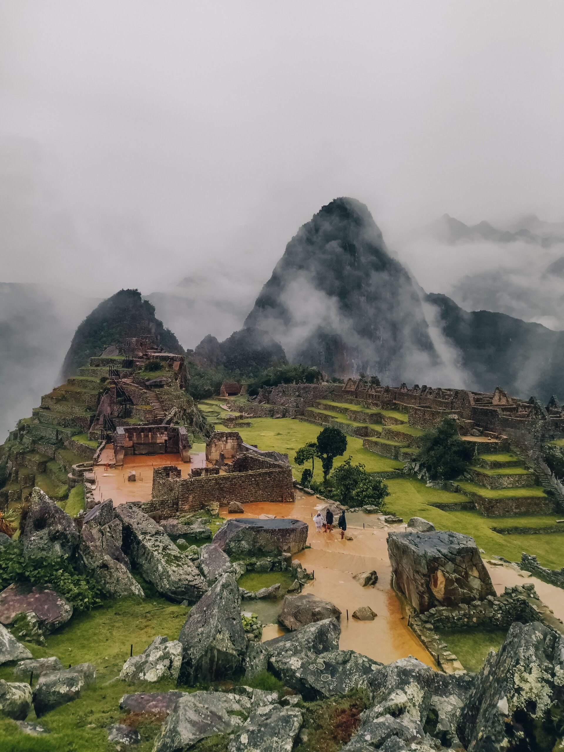 Explore the mystical ruins of Machu Picchu surrounded by misty mountains in Peru.